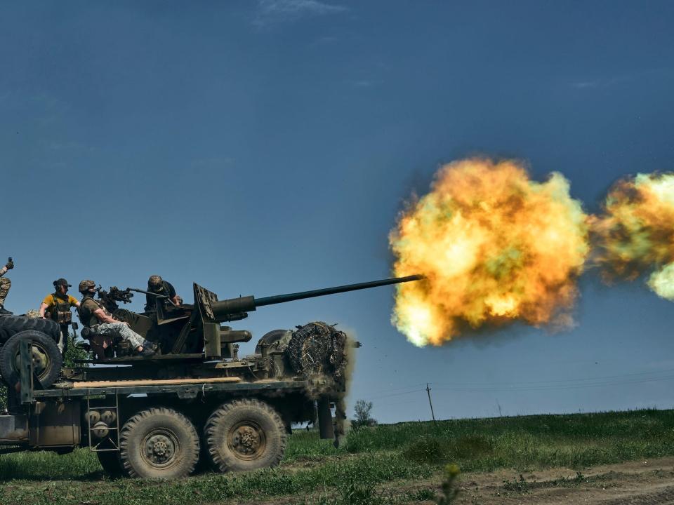 Ukrainian soldiers fire a cannon near Bakhmut, an eastern city where fierce battles against Russian forces have been taking place, in the Donetsk region, Ukraine, Monday, May 15, 2023