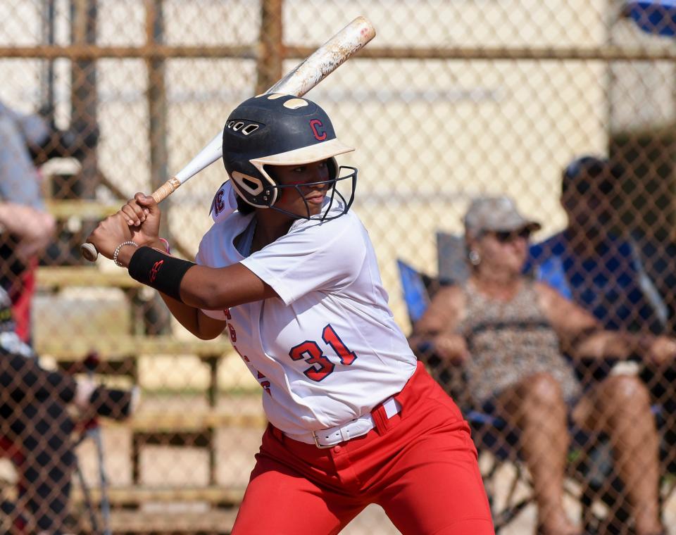 Centennial’s Carmela Baker (31) hits a pitch against Treasure Coast during a high school softball game on Wednesday, May 3, 2023, in Port St. Lucie. 
