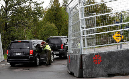 Canadian police check a car next to the red zone security perimeter around the Manoir Richelieu ahead of G7 Summit in La Malbaie, Canada June 5, 2018. REUTERS/Yves Herman