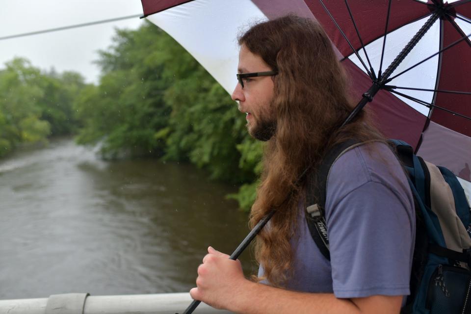 Chris Gendron crosses the bridge over the Blackstone River on Sutton Street in Northbridge Tuesday on his way to work.