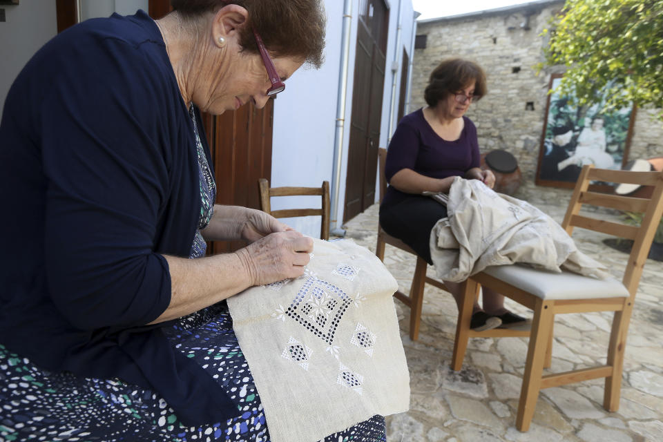 In this Tuesday Oct. 23, 2018, Eudokia Stavri, left, and Margarita Charalambous stitches famous Lefkaritiko laces in Lefkara village, Cyprus. Legend has it that the intricate needlework used in embroidery known as ‘Lefkaritiko lace’ was of such high quality that Leonardo Da Vinci himself bought a tablecloth when he visited this mountainous village in the late 15th century and gifted it to Milan’s cathedral. (AP Photo/Petros Karadjias)