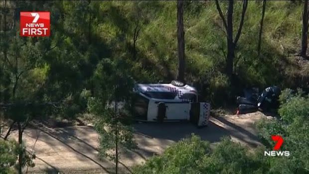 The police cruiser was overturned amid the chase and gunfight. Source: 7 News