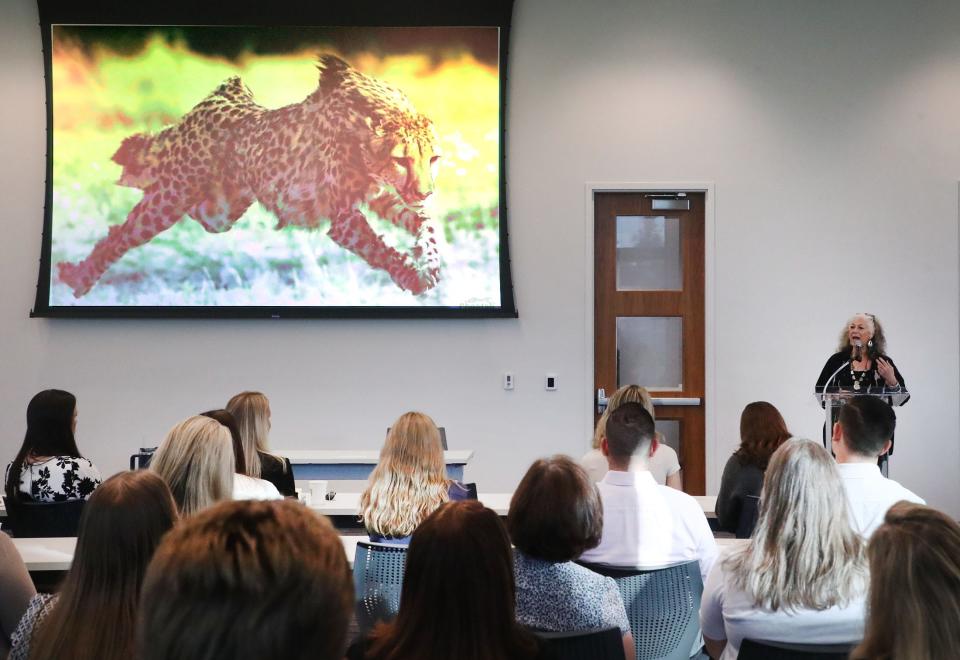 Dr. Laurie Marker, founder of the Cheetah Conservation Fund, addresses Brown & Brown "teammates" at the insurance brokerage's headquarters at 300 N. Beach St., Daytona Beach on Monday, Oct. 30, 2023. The company has been using the world's fastest land animal as its symbol since the 1980s.