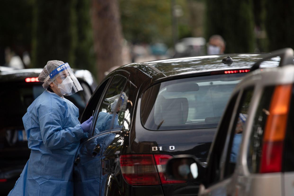 A medical worker prepares to proceed drive-through COVID-19 tests outside the Santa Maria della Pieta' hospital in Rome on October 12, 2020. (Photo by Tiziana FABI / AFP) (Photo by TIZIANA FABI/AFP via Getty Images)