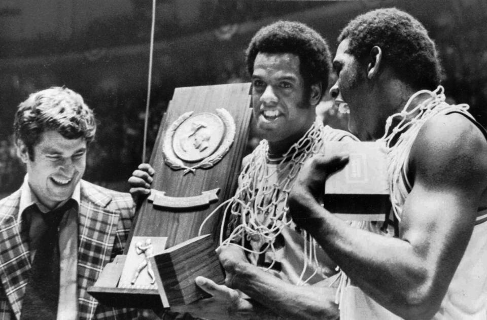 Indiana coach Bobby Knight celebrates with players Scott May and Quinn Buckner.