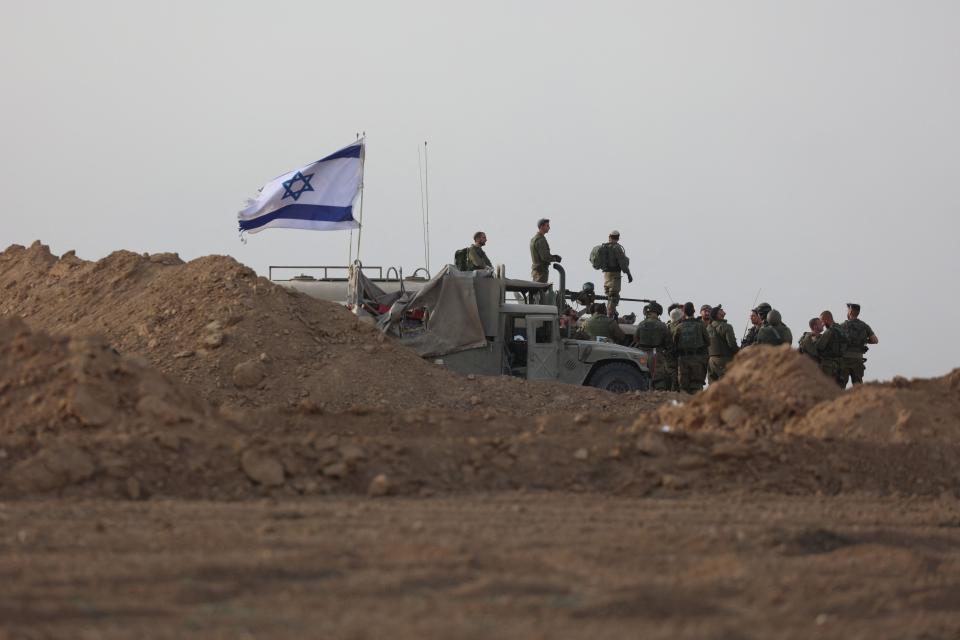 Israeli troops gather near the border with Gaza before entering on Oct. 29, 2023.
