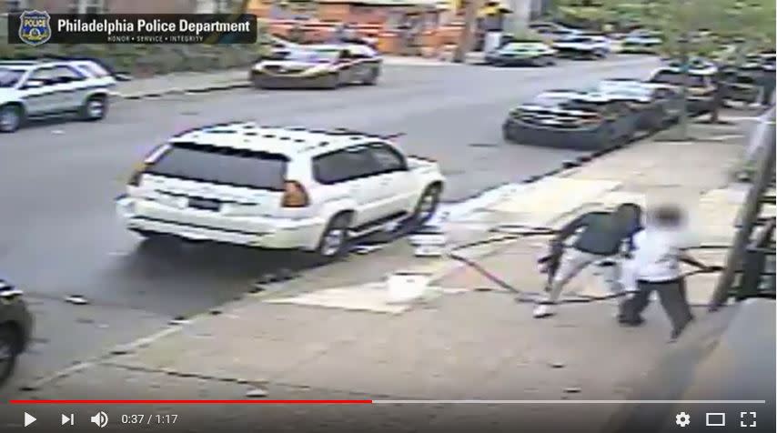 <span class="icon icon--xs icon__camera">  </span> <span class="credit font--s-m upper black"> <b>Philadelphia Police</b> </span> <div class="caption space-half--right font--s-m gray--med db"> An image from a surveillance video showing a man with an AK-47 assault-style rifle approaching Mike Poeng outside his West Philadelphia beer deli May 5. </div>