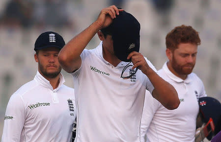 England's Alastair Cook (C) puts on his cap after loosing the match. India v England - Third Test cricket match - Punjab Cricket Association Stadium, Mohali, India - 29/11/16. REUTERS/Adnan Abidi