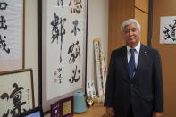 <p>Former Japanese Defense Minister Gen Nakatani stands in his office beside framed calligraphy with moral teachings and instructions. One work on display says that a person of virtue is not isolated and must have some companions. Another piece says the unvarnished truth is better than a cunning ruse and that honesty is the best policy. (Photo: Michael Walsh/Yahoo News) </p>