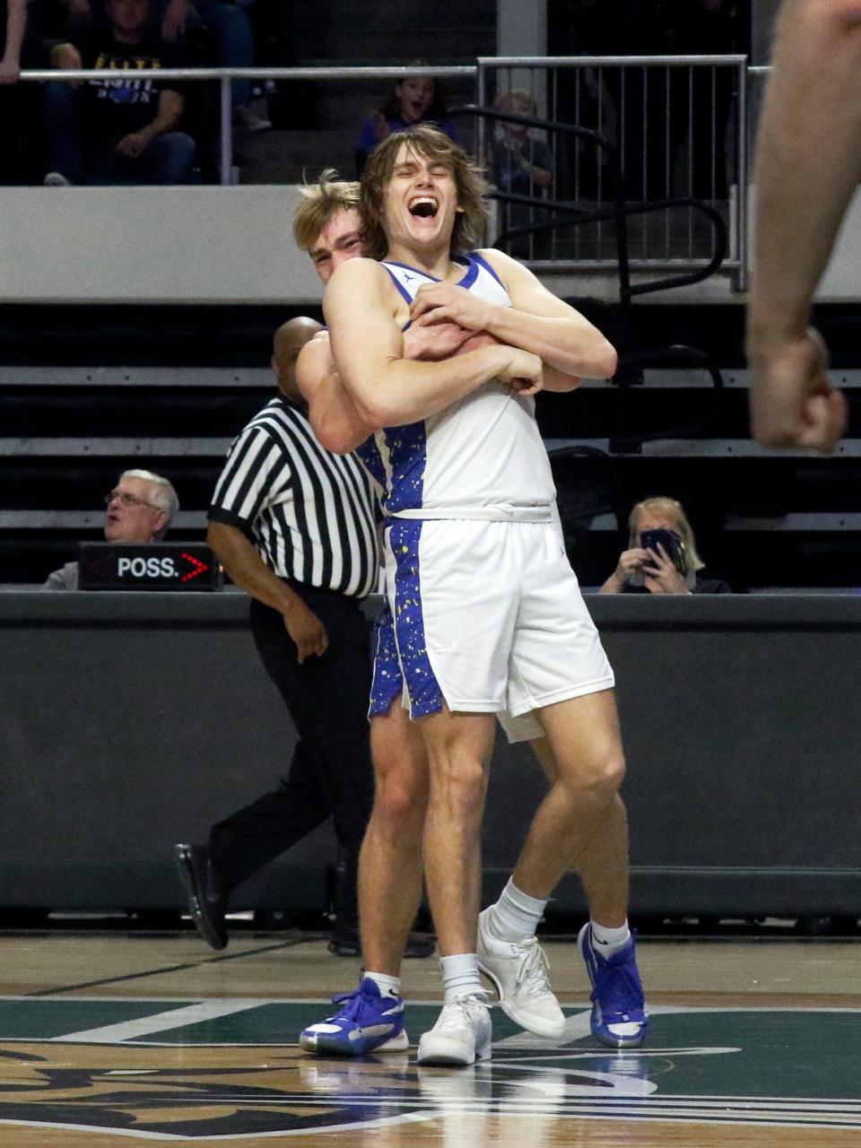 Senior Wesley Armstead, left, hugs classmate Alex Bobb during the final seconds of Maysville's 72-64 comeback win against Vincent Warren in a Division II regional final on Saturday at the Ohio Convocation Center in Athens. The two combined to hit 15 of 22 free throws as the Panthers won their first regional in 53 years.