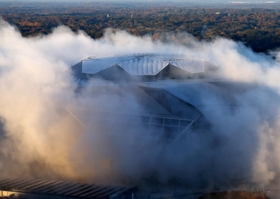 <p>A dust cloud engulfs the Mercedes-Benz Stadium following the implosion of the Georgia Dome, which was next door to the stadium in Atlanta. The Dome was the home of the Atlanta Falcons, hosted Super Bowls and the 1996 Summer Olympic Games among other sporting events. (AP Photo/John Bazemore) </p>