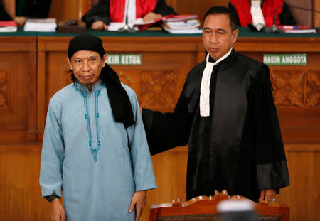 Islamic cleric Aman Abdurrahman arrives at a court with a member of his legal team ahead of his verdict in Jakarta, Indonesia, June 22, 2018. REUTERS/Darren Whiteside