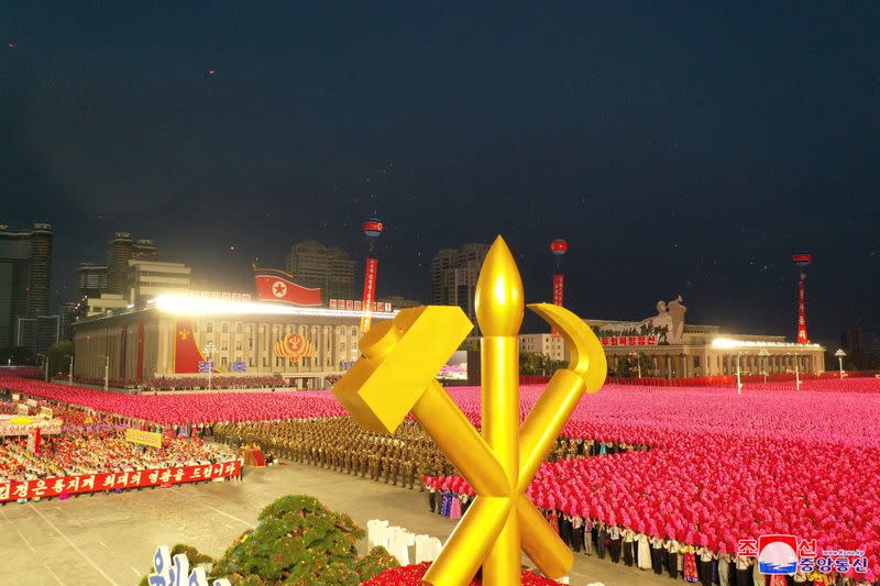 People take part in a procession to commemorate the 75th anniversary of the founding of the ruling Workers' Party of Korea (WPK), in Pyongyang