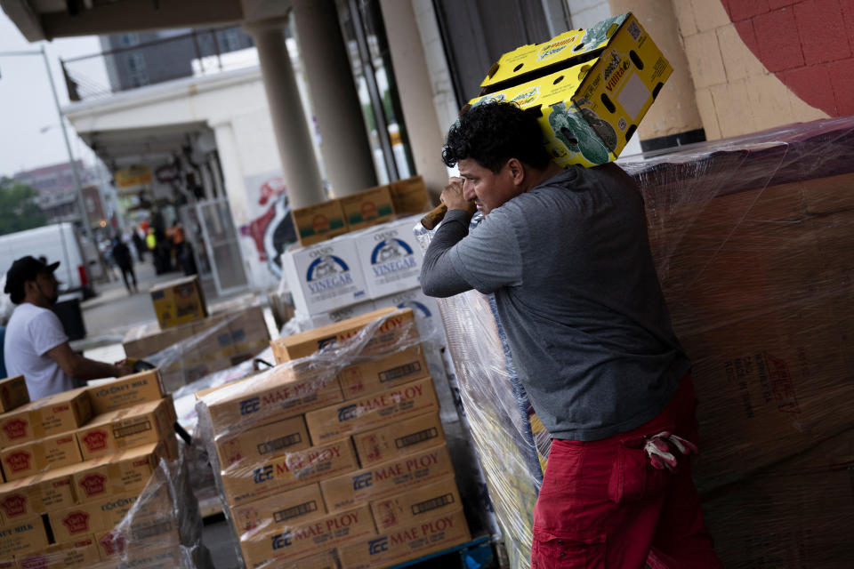 A worker walks past a wholesale market May 4, 2022, in Washington, DC. - The Federal Reserve on Wednesday raised the benchmark lending rate by a half percentage point in its ongoing effort to contain the highest inflation in four decades. (Photo by Brendan Smialowski / AFP) (Photo by BRENDAN SMIALOWSKI/AFP via Getty Images)