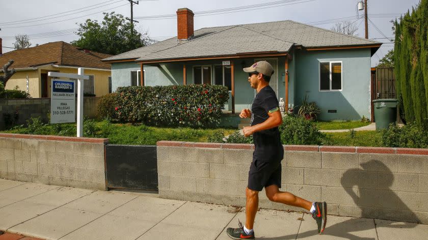 BURBANK, CALIF. - MARCH 26: A runner runs past a home, for sale along Buena Vista street, on Tuesday, March 26, 2019 in Burbank, Calif. (Kent Nishimura / Los Angeles Times)