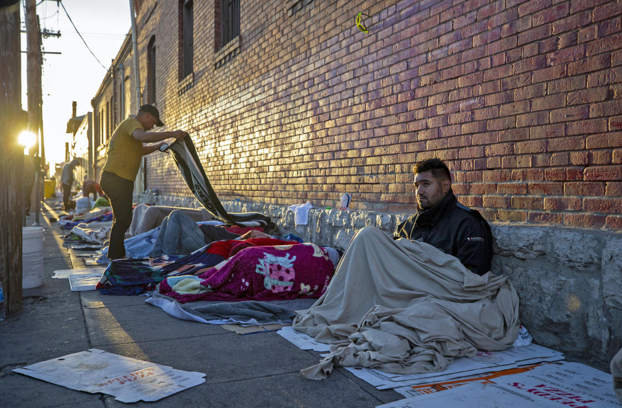 Migrants wake up at the campsite outside Sacred Heart Church in downtown El Paso, Texas, on May 9, 2023.  (Andres Leighton / AP)