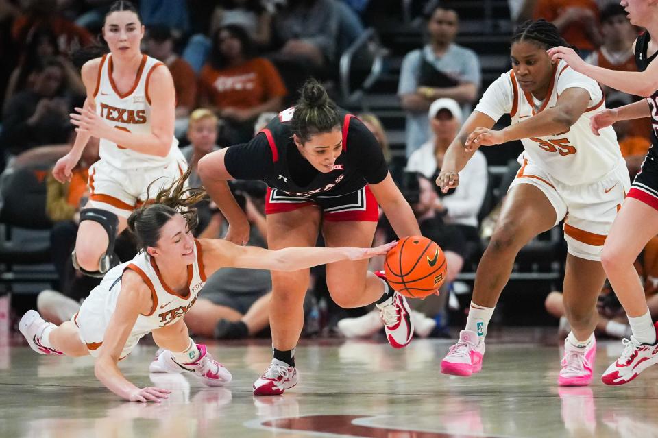 Texas' Shay Holle, Texas Tech's Jada Wynn and Texas' Madison Booker rush for a loose ball during Wednesday night's 77-72 Longhorns win at Moody Center.