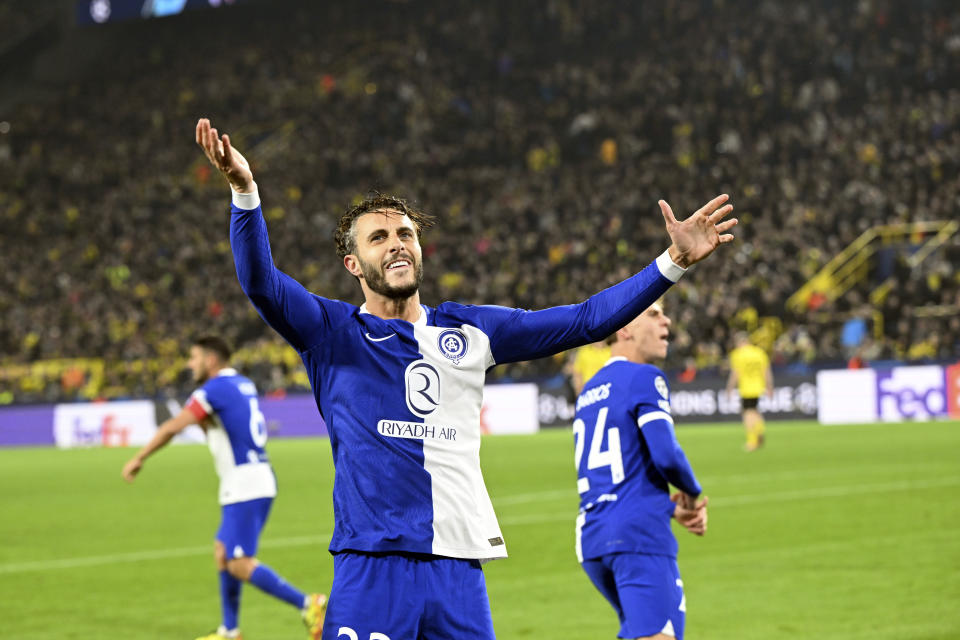 Atletico's Mario Hermoso celebrates scoring during the Champions League quarterfinal second leg soccer match between Borussia Dortmund and Atletico Madrid at the Signal-Iduna Park in Dortmund, Germany, Tuesday, April 16, 2024. (Federico Gambarini/dpa via AP)