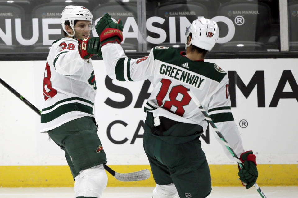 Minnesota Wild left wing Ryan Hartman, left, celebrates scoring with left wing Jordan Greenway against the Anaheim Ducks during the first period of an NHL hockey game in Anaheim, Calif., Wednesday, Jan. 20, 2021. (AP Photo/Alex Gallardo)