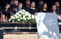 Nadene Lomu (L), widow of late rugby legend Jonah Lomu, walks past his casket during a memorial service at Eden Park in Auckland on November 30, 2015