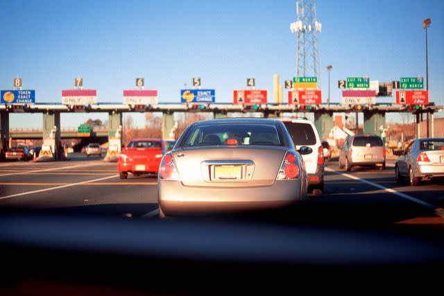 <p>Getty</p> Stock image of a car pulling into toll plaza - Garden State Parkway