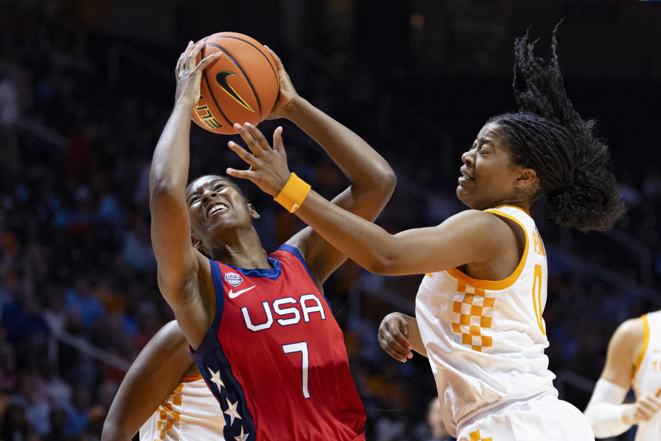 Team USA guard Ariel Atkins (7) goes to shoot as she collides with Tennessee guard Jewel Spear (0) during the first half of an NCAA college basketball exhibition game, Sunday, Nov. 5, 2023, in Knoxville, Tenn. (AP Photo/Wade Payne)