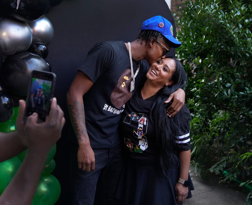 Wearing the hat of his new college team, former RI high schooler, Naeshaun Montgomery, gives his mom, Natasha Alvarez, a kiss after he commits to play football at with the University of Florida Gators on Sunday evening, August 25, 2024.