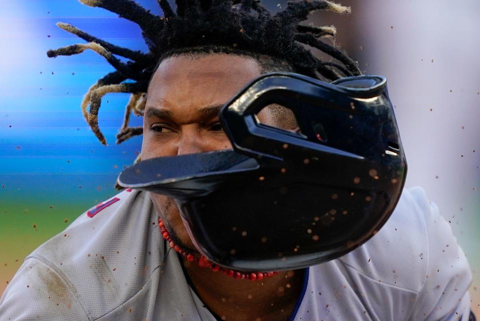 Cleveland Guardians Jose Ramirez dives safely into third base after hitting a double and advancing on a throwing error by the New York Yankees during Game 2 of an American League Division baseball series on Oct. 14, 2022, in New York.