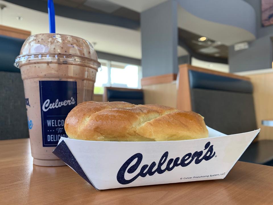 Culver's milkshake and sandwich in blue and white packaging in restaurant