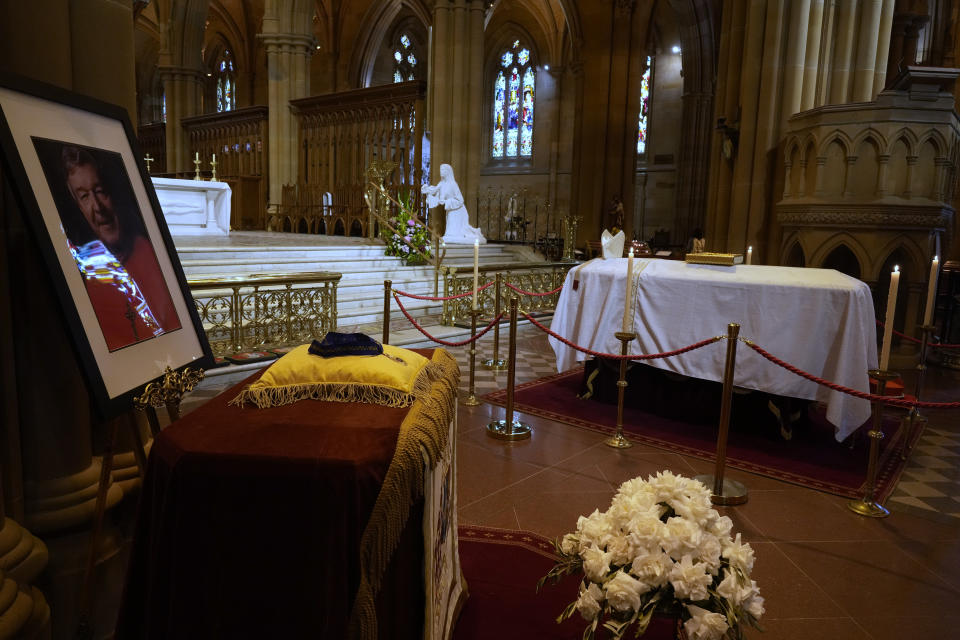 The coffin of Cardinal George Pell lays in state at St. Mary's Cathedral in Sydney, Wednesday, Feb. 1, 2023. Mourners paid their respects to Cardinal George Pell who lay in state in a Sydney cathedral on Wednesday as police sought a court order to prevent protesters from disrupting his funeral. (AP Photo/Rick Rycroft, Pool)