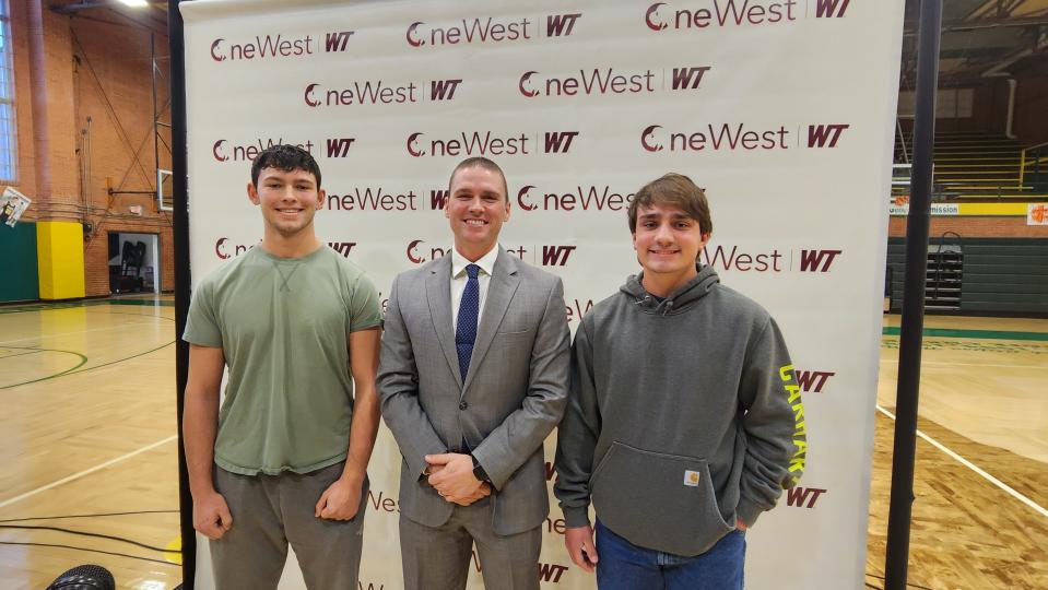 Pampa High School Principal Clay Jones is flanked by seniors Tyce Whiteley, left, and Riley Covle, right, at a news conference announcing a new scholarship at the school in Pampa.