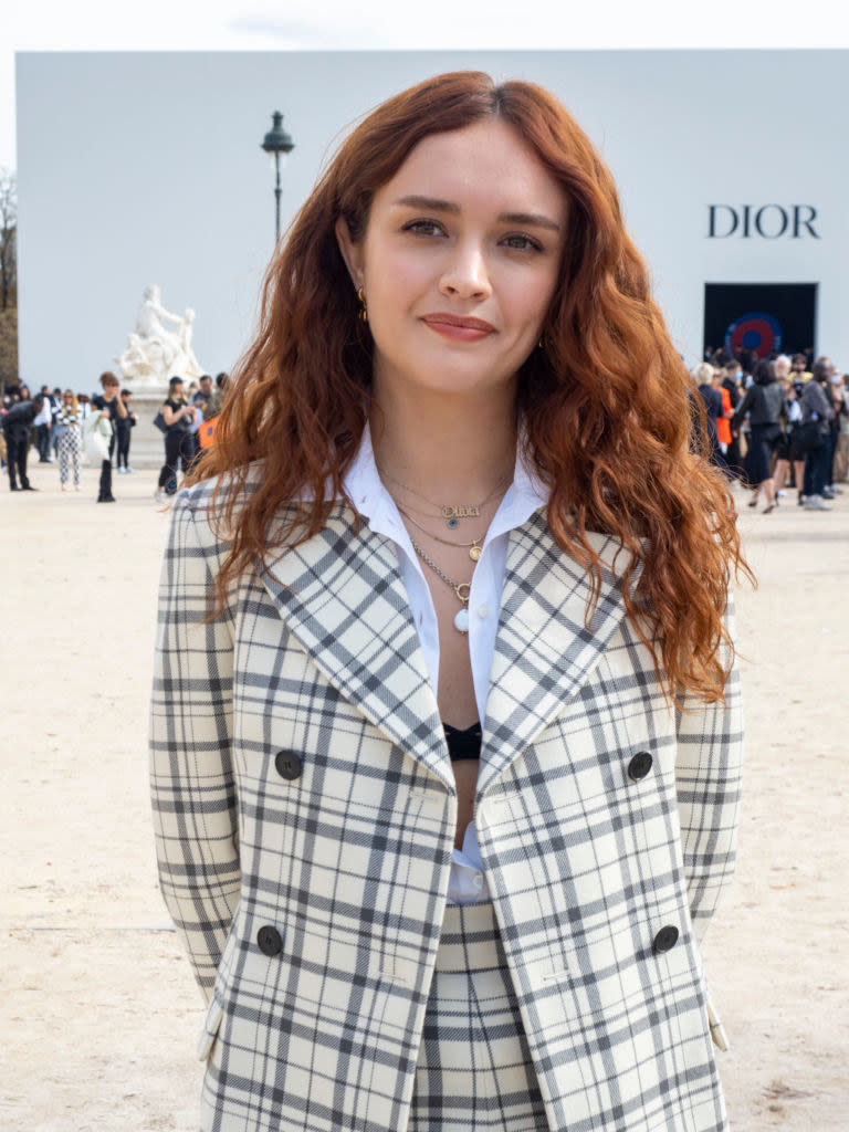 Olivia Cooke is seen during the Paris Fashion Week in a plaid suit