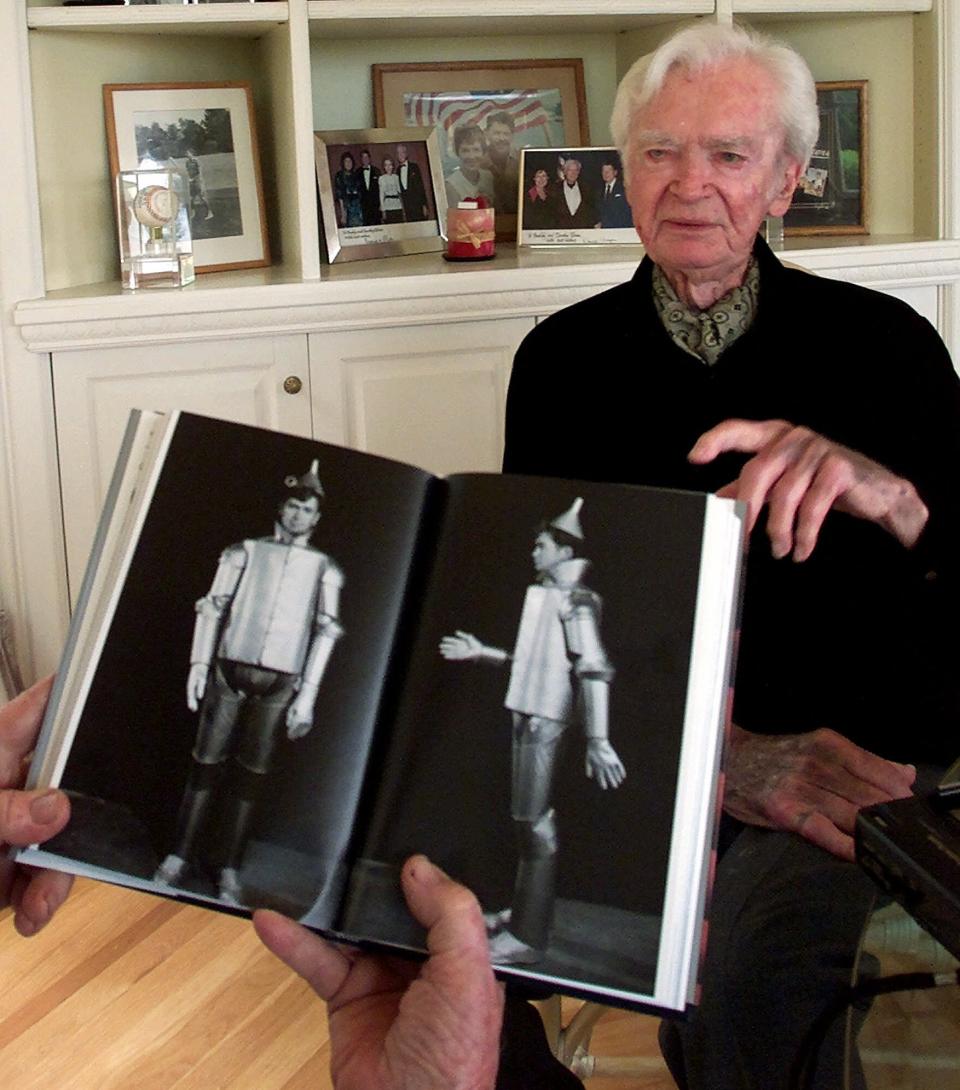 Actor Buddy Ebsen, 93, points to a book that shows him wearing the costume of the Wizard of Oz' Tin Man, during an interview at his home in Palos Verdes Estates, Calif., May 24, 2001. Ebsen and his sister Vilma danced in hit Broadway shows, including "The Ziegfeld Follies of 1934."  In 2001, Ebsen started a new career in fiction writing. His novel "Kelly's Quest," released by an e-book publisher based in Indiana, became a best seller. (AP Photo/Damian Dovarganes)