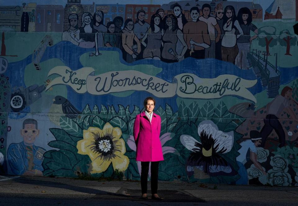 Former Mayor Lisa Baldelli-Hunt stands in front of a mural in the parking lot across from the Woonsocket City Hall in 2022.