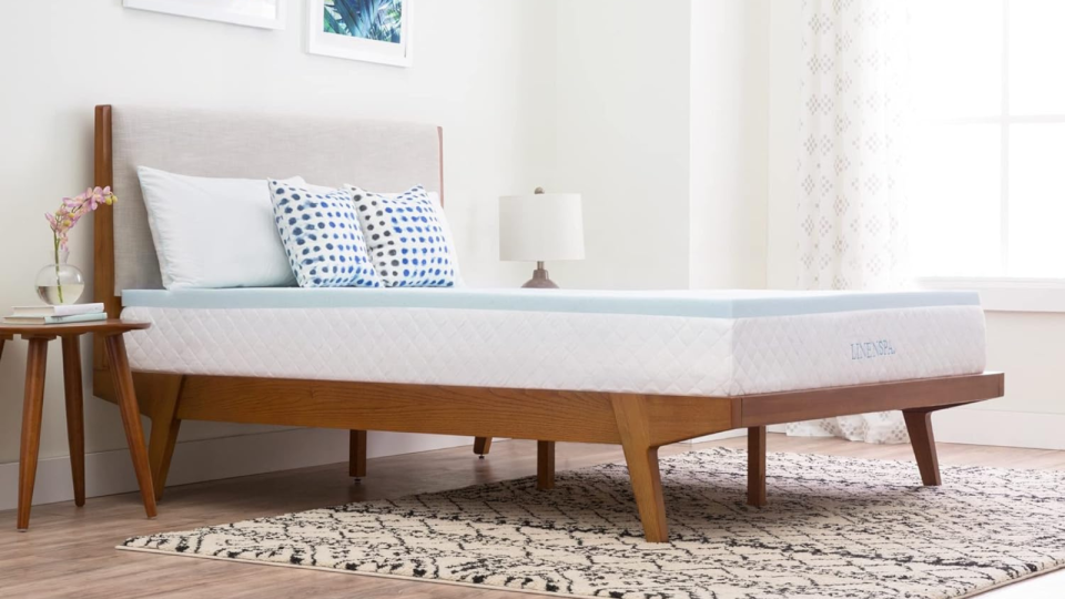 the light blue linenspa mattress topper on a bed