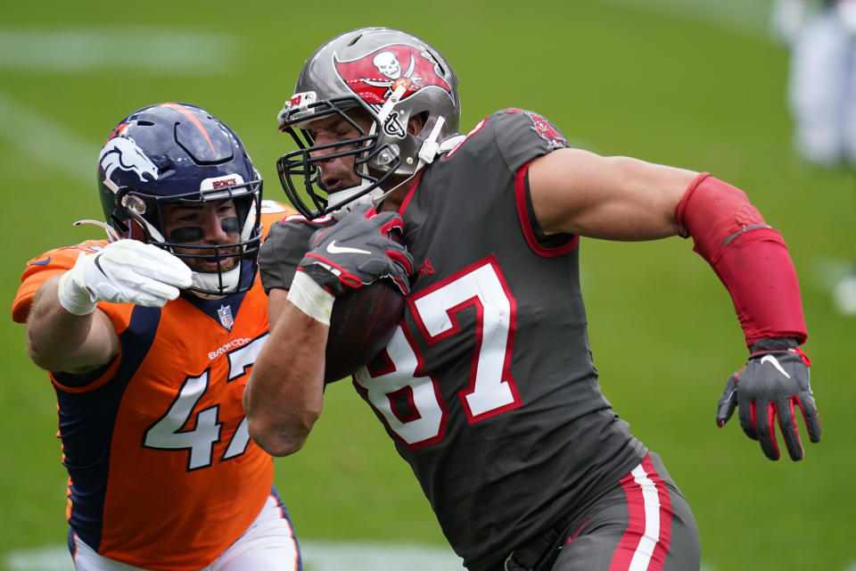 Tampa Bay Buccaneers tight end Rob Gronkowski, right, runs with the ball as Denver Broncos inside linebacker Josey Jewell defends during the first half of an NFL football game Sunday, Sept. 27, 2020, in Denver. (AP Photo/Jack Dempsey)