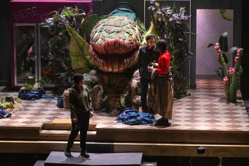 Puppeteer Zachery Garner, right, stood on stage after operating the giant, Audrey II man-eating plant puppet during the final dress rehearsal for the KC Rep’s production of the “Little Shop of Horrors.”