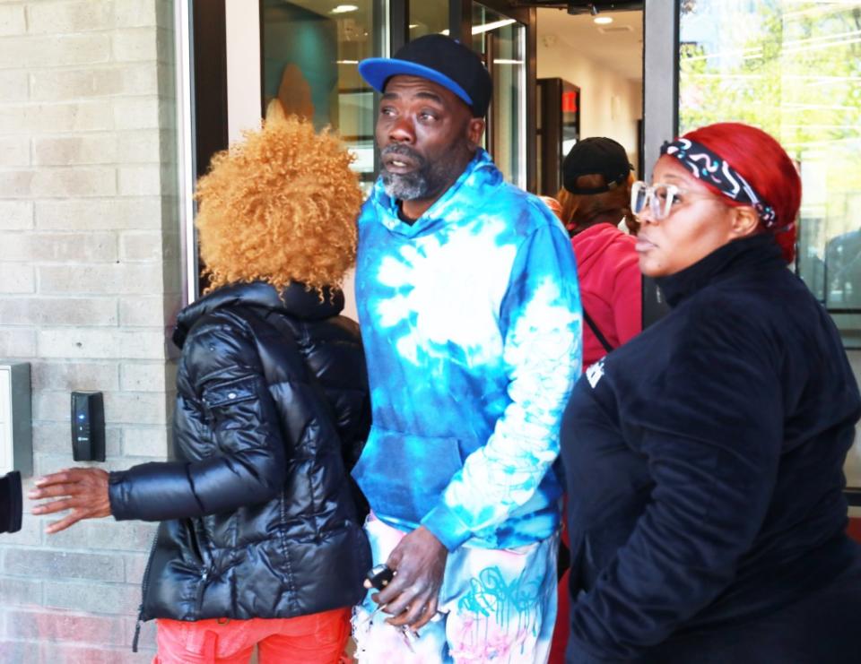 Robinson’s family members outside the building where he was mauled to death by a pit bull. Tomas E.Gaston