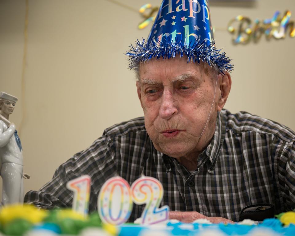 Stanley Potrzeba blows out the candles during his 102nd birthday party at the New York Mills Community Center on Tuesday, May 14, 2024.
