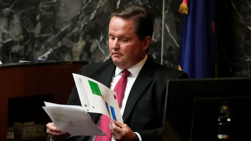 Forensic analyst Ed Wagrowski looks over text messages while on the stand in an Oakland County courtroom Friday in Pontiac, Michigan. - Carlos Osorio/Pool/AP