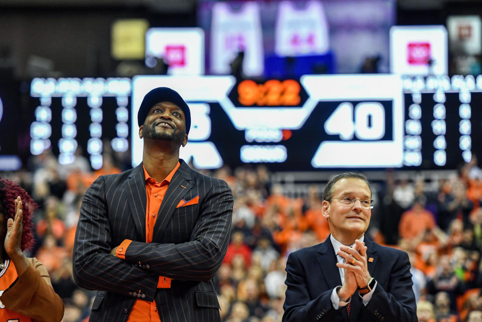 Former Syracuse player John Wallace watches as his jersey is retired and unveiled in the rafters of the Carrier Dome during halftime of an NCAA college basketball game between Syracuse and North Carolina in Syracuse, N.Y., Saturday, Feb. 29, 2020. (AP Photo/Adrian Kraus)