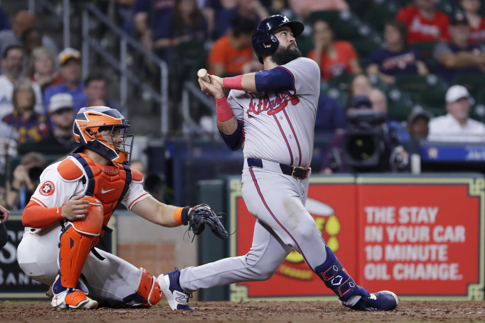 Atlanta Braves Luis Guillorme watches his two-run double next to Houston Astros catcher Yainer Diaz during the ninth inning of a baseball game Tuesday, April 16, 2024, in Houston. (AP Photo/Michael Wyke)
