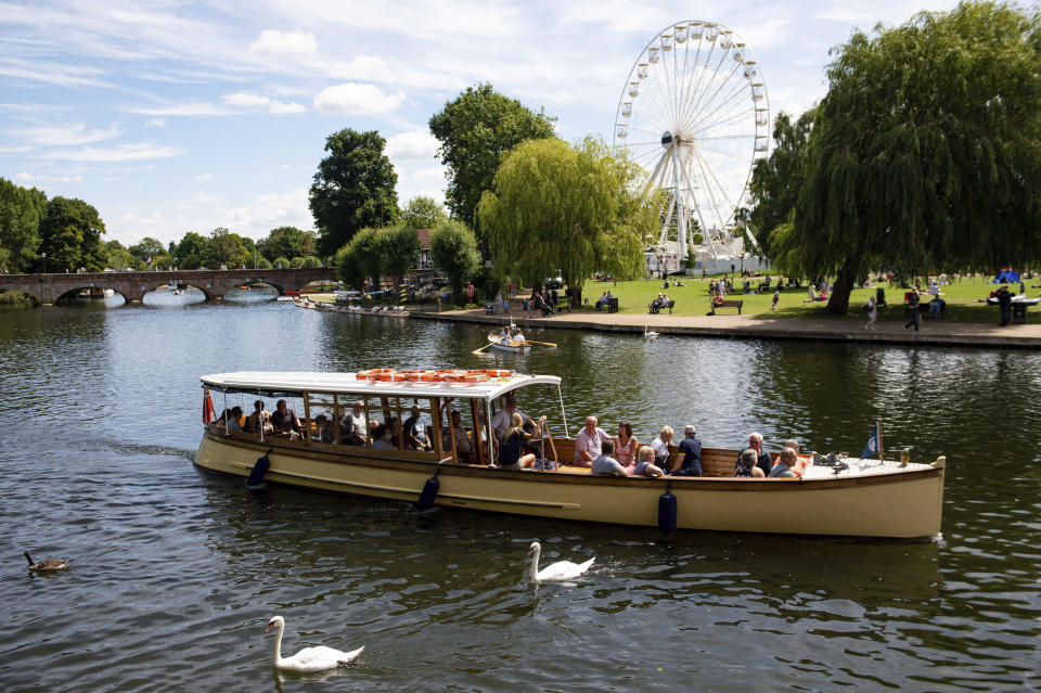 People enjoy a boat trip on a warm day in Stratford-upon-Avon, England, Sunday July 12, 2020. (Jacob King/PA via AP)