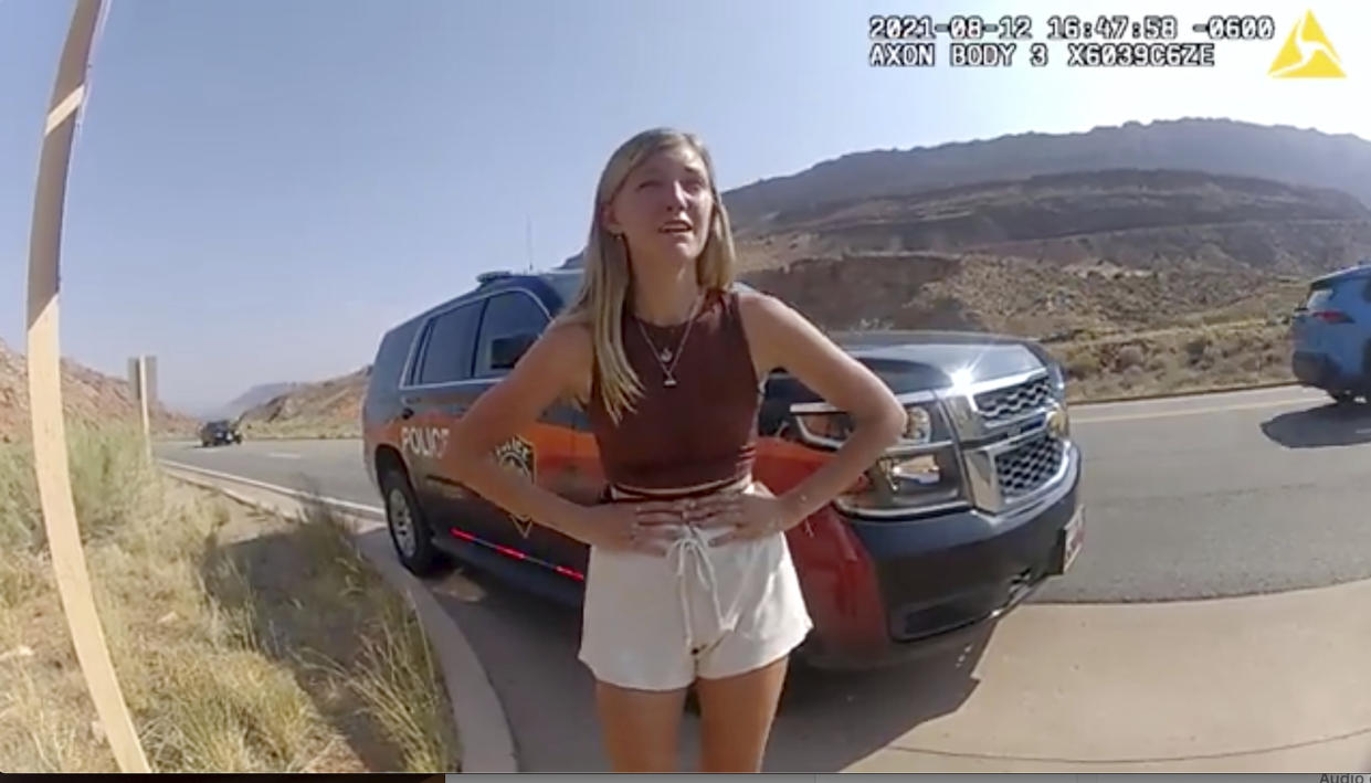 FILE - In this image taken from police body camera video provided by The Moab Police Department, Gabrielle "Gabby" Petito talks to a police officer after police pulled over the van she was traveling in with her boyfriend, Brian Laundrie, near the entrance to Arches National Park on Aug. 12, 2021. Gabby Petito's family filed a wrongful death lawsuit alleging that police failed to recognize their daughter was in a life-threatening situation last year when officers investigated a fight between her and her boyfriend. (The Moab Police Department via AP, File)