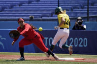 Australia's Leah Parry (44) is safe at first base as United States' Valerie Arioto (20) reaches for the throw in the third inning of a softball game at the 2020 Summer Olympics, Sunday, July 25, 2021, in Yokohama, Japan. (AP Photo/Sue Ogrocki)