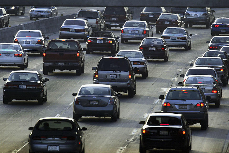 Traffic on a highway with multiple lanes and various cars heading in the same direction