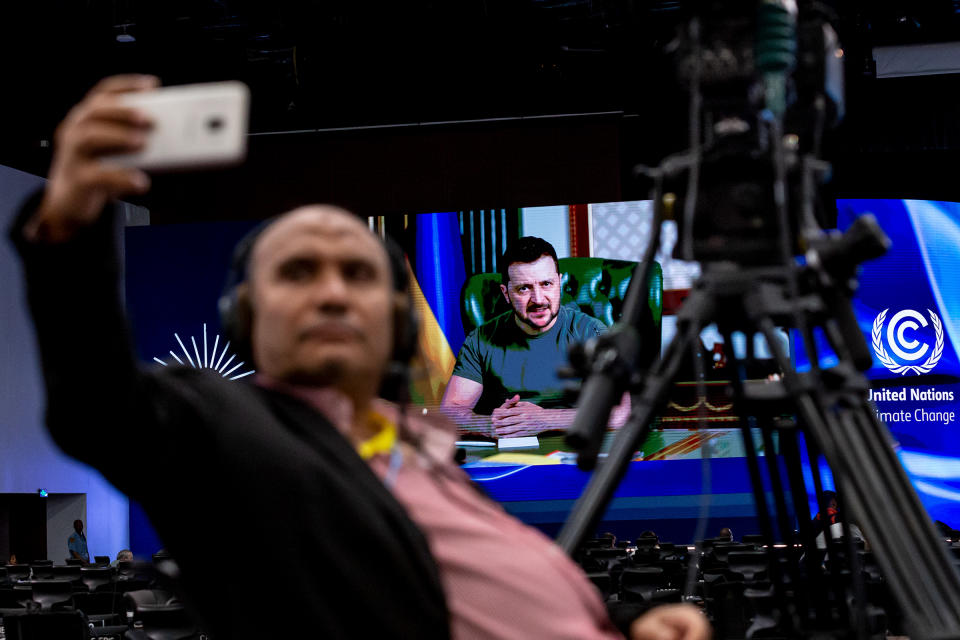 A cameraman takes a selfie as Ukrainian President Volodymyr Zelensky delivers his statement via video on the third day of the COP27 U.N. Climate Change Conference in Sharm el-Sheikh, Egypt on Nov. 8.<span class="copyright">Dominika Zarzycka—NurPhoto/Shutterstock</span>