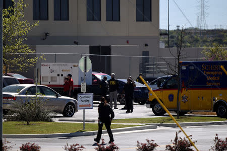 Law enforcement personnel attend the scene of a blast at a FedEx facility in Schertz, Texas, U.S., March 20, 2018. REUTERS/Sergio Flores