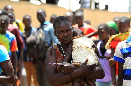 South Sudanese refugee woman, displaced by fighting, holds her child on arrival at Imvepi settlement in Arua district, northern Uganda, April 4, 2017. Picture taken April 4, 2017. REUTERS/James Akena