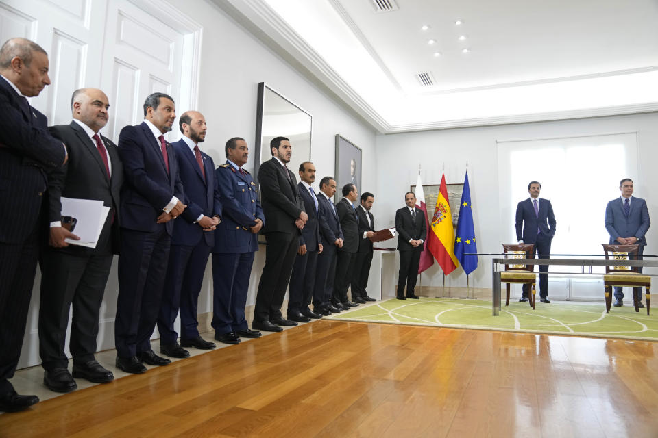 Qatar government ministers wait to sign an investment agreement with Spain in the presence of the Emir of Qatar Sheikh Tamim bin Hamad Al Thani, 2nd from right and Spain's Prime Minister Pedro Sanchez at the Moncloa Palace in Madrid, Spain, Wednesday, May 18, 2022. The emir of Qatar said that his energy-rich gulf state is set to boost investments in Spain by 4.7 billion euros (4.9 billion) dollars in the coming years, Spanish media reported late on Tuesday. The details of the investments have not been made public but with Europe scrambling to find alternatives to Russian energy, Qatar is positioned to help fill the gap with exports of liquified natural gas. (AP Photo/Paul White)